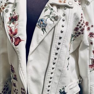Embroidered white faux leather jacket..